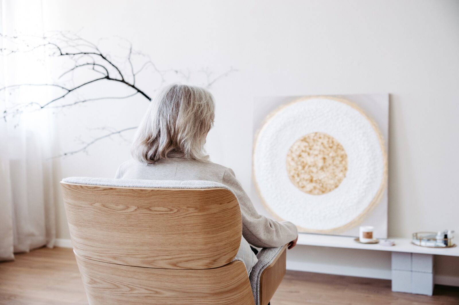 Person im Sessel vor dem goldenen Kunstwerk